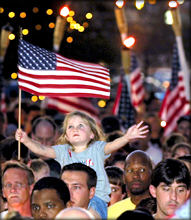 A young child celebrates American patriotism with her family in a memorial service. (abc)